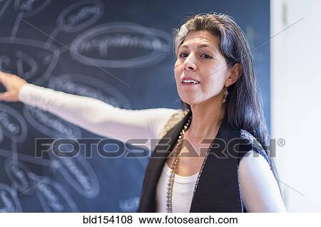 Hispanic businesswoman drawing flow chart on blackboard View Large Photo Image Stock Photo - Hispanic businesswoman drawing flow chart on blackboard. Fotosearch