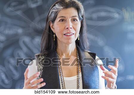 Stock Photo - Hispanic businesswoman talking in office. Fotosearch