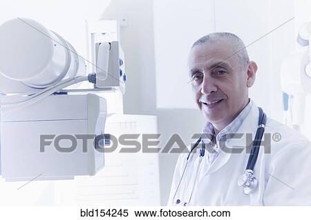 Hispanic doctor smiling in hospital View Large Photo Image Stock Photography - Hispanic doctor smiling in hospital. Fotosearch
