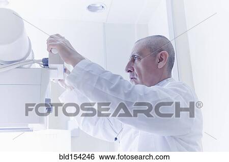 Hispanic doctor using x-ray machine View Large Photo Image Stock Photograph - Hispanic doctor using x-ray machine. Fotosearch