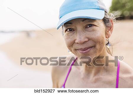 Japanese woman smiling on beach View Large Photo Image Stock Photo - Japanese woman smiling on beach. Fotosearch