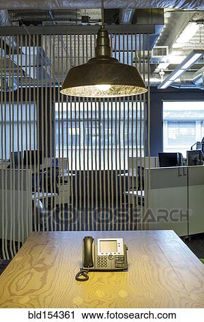 Light fixture over phone in office conference room View Large Photo Image Stock Image - Light fixture over phone in office conference room. Fotosearch
