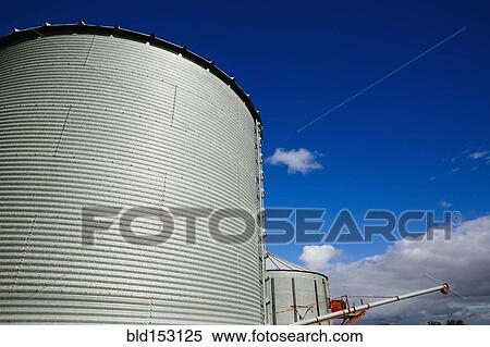 Low angle view of silos under blue sky View Large Photo Image Stock Photography - Low angle view of silos under blue sky. Fotosearch