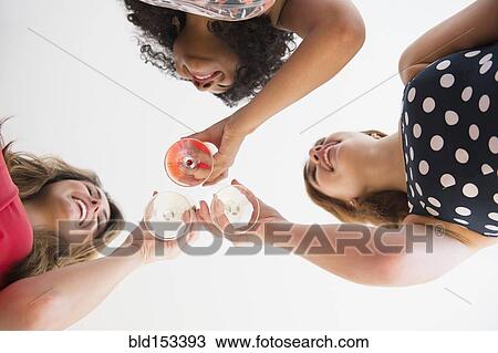 Low angle view of women toasting with cocktails View Large Photo Image Stock Image - Low angle view of women toasting with cocktails. Fotosearch