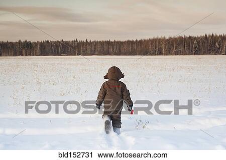 Mari boy walking in snowy field View Large Photo Image Stock Image - Mari boy walking in snowy field. Fotosearch