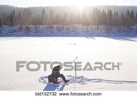 Mari man ice fishing in snowy field View Large Photo Image Stock Image - Mari man ice fishing in snowy field. Fotosearch