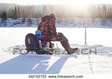 Mari man ice fishing in snowy field View Large Photo Image Stock Image - Mari man ice fishing in snowy field. Fotosearch