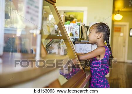 Mixed race girl ordering in cafe View Large Photo Image Stock Image - Mixed race girl ordering in cafe. Fotosearch