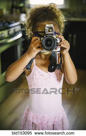 Mixed race girl photographing with camera View Large Photo Image Stock Photography - Mixed race girl photographing with camera. Fotosearch