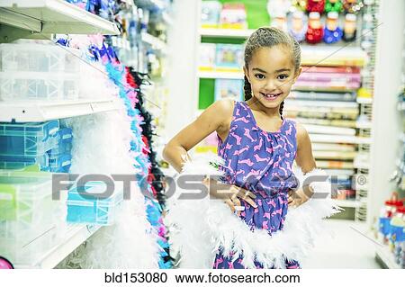 Mixed race girl playing dress-up in party store View Large Photo Image Stock Image - Mixed race girl playing dress-up in party store. Fotosearch