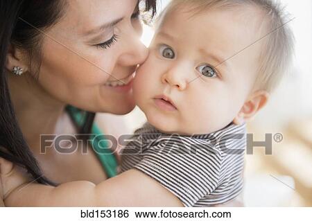 Stock Photograph - Mixed race mother holding baby. Fotosearch