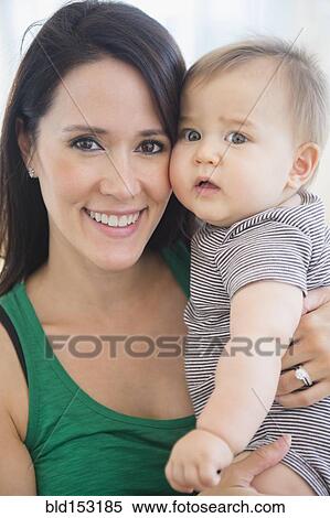 Mixed race mother holding baby View Large Photo Image Stock Photography - Mixed race mother holding baby. Fotosearch