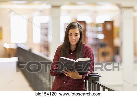Mixed race student reading in library View Large Photo Image Stock Image - Mixed race student reading in library. Fotosearch