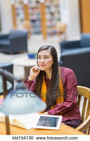 Mixed race student studying in library View Large Photo Image Stock Image - Mixed race student studying in library. Fotosearch