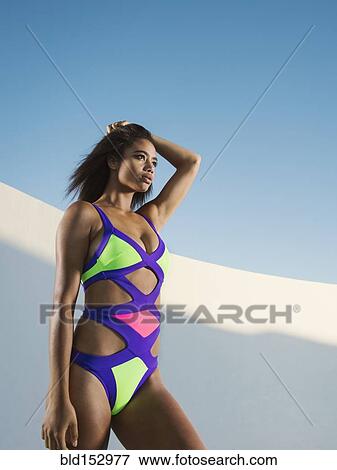 Mixed race woman wearing colorful swimsuit View Large Photo Image Stock Photo - Mixed race woman wearing colorful swimsuit. Fotosearch