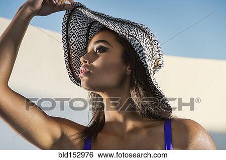 Mixed race woman wearing sun hat View Large Photo Image Stock Photograph - Mixed race woman wearing sun hat. Fotosearch
