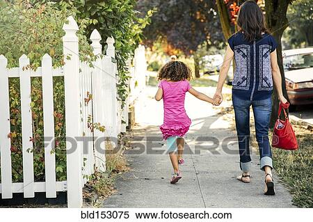Mother and daughter holding hands on sidewalk View Large Photo Image Stock Photography - Mother and daughter holding hands on sidewalk. Fotosearch