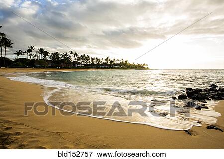 Stock Photo - Ocean waves washing up on tropical beach. Fotosearch