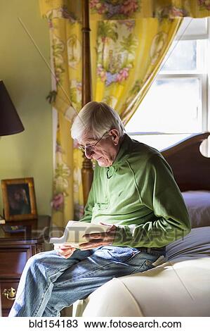 Older Caucasian man reading on bed View Large Photo Image Stock Image - Older Caucasian man reading on bed. Fotosearch