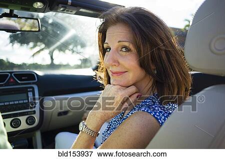 Stock Photo - Older Caucasian woman riding in convertible. Fotosearch