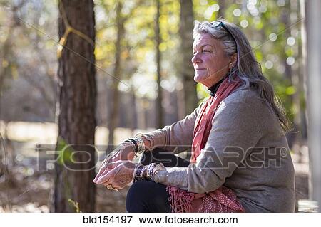 Stock Photo - Older Caucasian woman sitting outdoors. Fotosearch