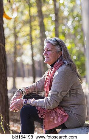 Older Caucasian woman sitting outdoors View Large Photo Image Stock Photo - Older Caucasian woman sitting outdoors. Fotosearch