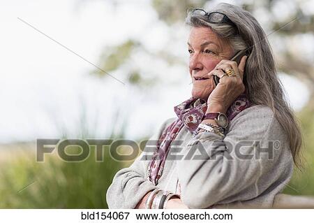 Older Caucasian woman talking on cell phone outdoors View Large Photo Image Stock Photo - Older Caucasian woman talking on cell phone outdoors. Fotosearch