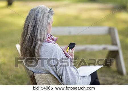 Older Caucasian woman using cell phone outdoors View Large Photo Image Stock Photography - Older Caucasian woman using cell phone outdoors. Fotosearch