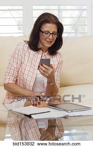 Stock Image - Older Caucasian woman working from home. Fotosearch