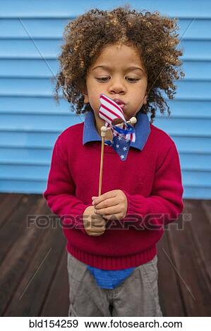 Pacific Islander boy blowing patriotic pinwheel View Large Photo Image Stock Photo - Pacific Islander boy blowing patriotic pinwheel. Fotosearch