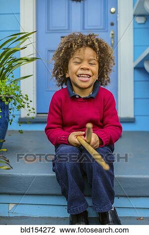 Pacific Islander boy with drumsticks sitting on front stoop View Large Photo Image Stock Image - Pacific Islander boy with drumsticks sitting on front stoop. Fotosearch
