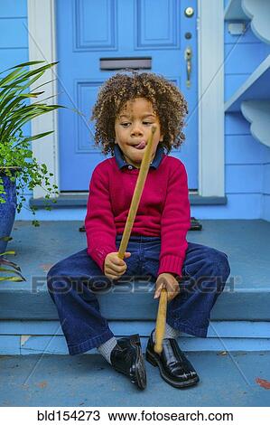 Pacific Islander boy with drumsticks sitting on front stoop View Large Photo Image Stock Image - Pacific Islander boy with drumsticks sitting on front stoop. Fotosearch