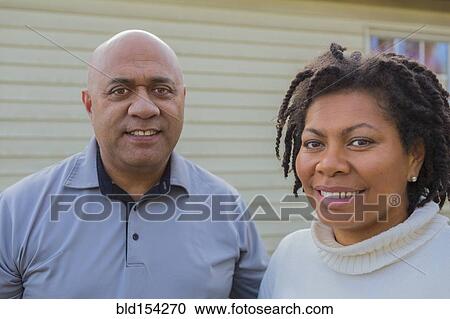 Stock Image - Pacific Islander couple smiling outdoors. Fotosearch