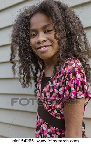 Stock Photography - Pacific Islander girl smiling outdoors. Fotosearch