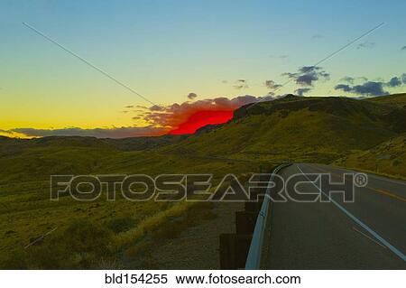 Red sunset over rural road and hillside View Large Photo Image Stock Photography - Red sunset over rural road and hillside. Fotosearch