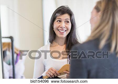 Small business owner talking to customer in store View Large Photo Image Stock Photograph - Small business owner talking to customer in store. Fotosearch