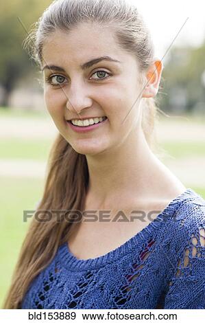 Stock Photo - Smiling Caucasian woman standing outdoors. Fotosearch