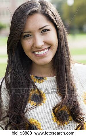 Smiling Hispanic woman standing outdoors View Large Photo Image Stock Photo - Smiling Hispanic woman standing outdoors. Fotosearch
