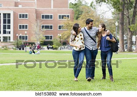 Stock Image - Smiling students walking on campus. Fotosearch