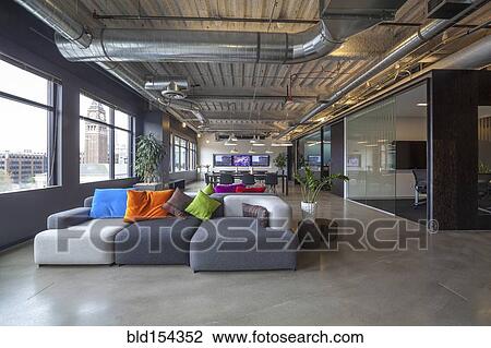 Stock Image - Sofas in office seating area. Fotosearch