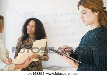 Stock Image - Student using digital tablet in classroom. Fotosearch
