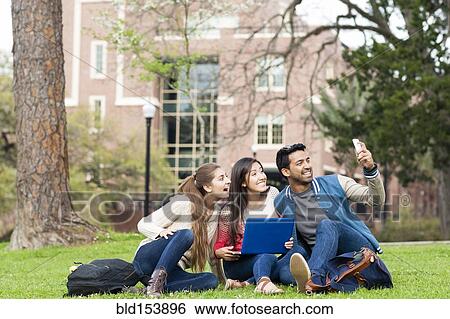 Students taking cell phone photograph on campus View Large Photo Image Stock Photograph - Students taking cell phone photograph on campus. Fotosearch