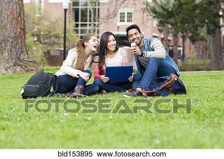 Stock Photography - Students taking cell phone photograph on campus. Fotosearch