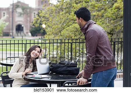 Stock Image - Students talking on campus. Fotosearch
