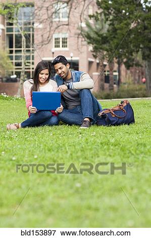 Stock Photo - Students using laptop on campus. Fotosearch
