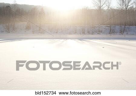 Sun shining over snowy field View Large Photo Image Picture - Sun shining over snowy field. Fotosearch
