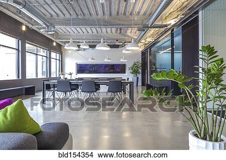 Picture - Tables in open office dining area. Fotosearch