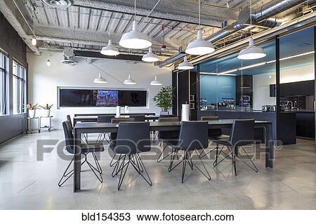 Stock Image - Tables in open office dining area. Fotosearch