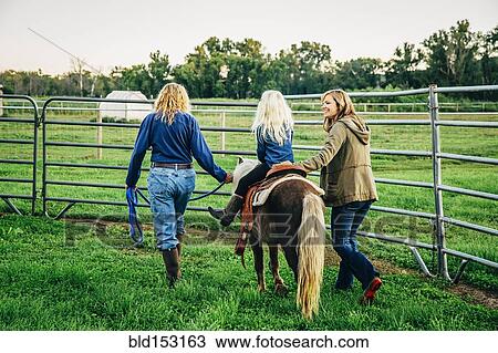 Three generations of Caucasian women walking miniature horse on farm View Large Photo Image Stock Image - Three generations of Caucasian women walking miniature horse on farm. Fotosearch