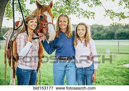 Three generations of Caucasian women standing near horse on farm View Large Photo Image Stock Photo - Three generations of Caucasian women standing near horse on farm. Fotosearch